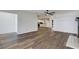 Open-concept living area with wood-look floors, adjacent to the kitchen and dining nook at 5722 Antler Trl, Lakeland, FL 33811