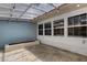 Open patio with translucent roofing, lightbulbs, brick detail and windows at 5722 Antler Trl, Lakeland, FL 33811