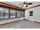 Sunroom features brick walls, tiled floor, wood trim, and plentiful windows for natural light at 5722 Antler Trl, Lakeland, FL 33811