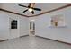 Sunroom featuring white brick walls, tiled floor, ceiling fan and multiple windows at 5722 Antler Trl, Lakeland, FL 33811