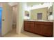Bathroom showcasing double vanity with granite countertop and tiled floors with door to toilet room at 6524 Great Bear Drive Blvd, Lakeland, FL 33805