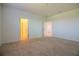 Neutral bedroom features beige carpeting, white walls, and two entryways leading to other rooms at 6524 Great Bear Drive Blvd, Lakeland, FL 33805