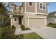 Well-kept two-story home with a two-car garage, complemented by green grass and landscaping at 6524 Great Bear Drive Blvd, Lakeland, FL 33805