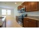 Well-equipped kitchen with stainless steel appliances and granite countertops, next to a naturally lit dining area at 6524 Great Bear Drive Blvd, Lakeland, FL 33805