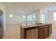 Kitchen island featuring a stainless steel dishwasher and sink, connecting to an open living area at 6524 Great Bear Drive Blvd, Lakeland, FL 33805