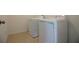 Modern laundry room features stacked washer and dryer and tile floors at 6524 Great Bear Drive Blvd, Lakeland, FL 33805