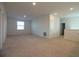 A spacious living area with plush carpeting and natural light streaming through the window at 6524 Great Bear Drive Blvd, Lakeland, FL 33805