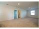 A spacious living area with neutral carpeting, a window, and bright white walls at 6524 Great Bear Drive Blvd, Lakeland, FL 33805