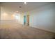 A large open loft area featuring plush carpeting and bright walls at 6524 Great Bear Drive Blvd, Lakeland, FL 33805