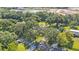 Aerial view showing the home, shed, and expansive property with trees at 6533 Angus Dr, Lakeland, FL 33810