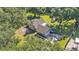 Aerial view showcasing the home, large yard, shed, and surrounding greenery at 6533 Angus Dr, Lakeland, FL 33810