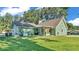 Large backyard with green grass, mature trees, and a charming exterior, offering tranquility and privacy at 6533 Angus Dr, Lakeland, FL 33810