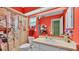 Functional bathroom features a vanity, toilet, and shower with bright orange walls and decor, offering convenience at 6533 Angus Dr, Lakeland, FL 33810