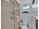 Bathroom featuring a glass enclosed shower with a decorative window and modern fixtures at 6533 Angus Dr, Lakeland, FL 33810
