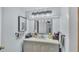 Bathroom featuring a vanity with storage, white countertop, a large mirror, and modern lighting fixtures at 6533 Angus Dr, Lakeland, FL 33810