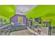 Bright bedroom with unique purple and green paint, carpeted floors, offering a fun and vibrant personal space at 6533 Angus Dr, Lakeland, FL 33810