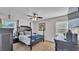 Comfortable bedroom with a four-poster bed, ample natural light, and dark wood furnishings at 6533 Angus Dr, Lakeland, FL 33810
