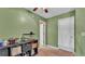 Bedroom space with green walls, neutral carpet, storage, and neutral walls, ideal for comfort and relaxation at 6533 Angus Dr, Lakeland, FL 33810