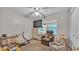 Cozy bedroom featuring neutral walls, a comfortable chair, and a window with natural light at 6533 Angus Dr, Lakeland, FL 33810