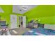 Bright bedroom with vibrant green walls, carpet, and plenty of space, creating an energetic and personalized area at 6533 Angus Dr, Lakeland, FL 33810