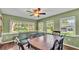 Dining area with natural lighting from windows and dark wood table and chairs at 6533 Angus Dr, Lakeland, FL 33810