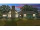 Charming home exterior featuring a stone chimney and large windows at 6533 Angus Dr, Lakeland, FL 33810