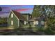 View of the green home's exterior showing the backyard and windows at 6533 Angus Dr, Lakeland, FL 33810