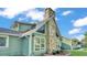 Detailed shot of stone chimney and windows, creating a unique exterior at 6533 Angus Dr, Lakeland, FL 33810