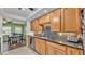 Kitchen with granite countertops, wood cabinets, tile backsplash, and stainless steel appliances at 6533 Angus Dr, Lakeland, FL 33810