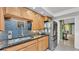 Kitchen area featuring a sink with granite countertops, stainless steel appliances, and wooden cabinets at 6533 Angus Dr, Lakeland, FL 33810