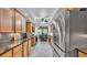 Well-lit kitchen featuring wood cabinets, granite countertops, and stainless steel appliances at 6533 Angus Dr, Lakeland, FL 33810