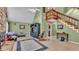 Bright living room featuring a stone fireplace, vaulted ceilings, and an open staircase at 6533 Angus Dr, Lakeland, FL 33810