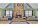 Spacious living room featuring a stone fireplace and comfortable seating at 6533 Angus Dr, Lakeland, FL 33810
