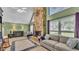 Cozy living room with a stone fireplace, large windows, and comfortable seating at 6533 Angus Dr, Lakeland, FL 33810