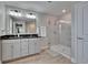 Modern bathroom featuring dual sinks, granite counters, and a glass shower at 7116 Cruz Ct, Lakeland, FL 33813