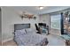 Charming bedroom with playful decor, wood-look floors, and a dedicated workspace at 7116 Cruz Ct, Lakeland, FL 33813