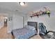 Relaxing bedroom featuring wood-look flooring, white closet, and plush bed with desk at 7116 Cruz Ct, Lakeland, FL 33813