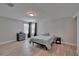 Bright bedroom with wood-look flooring, a bed, and contemporary furnishings at 7116 Cruz Ct, Lakeland, FL 33813