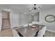 Dining area featuring modern lighting, neutral walls, and wood-look floors, adjacent to staircase at 7116 Cruz Ct, Lakeland, FL 33813
