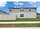 Exterior shot of a two-story home with a well-maintained backyard and white fence at 7116 Cruz Ct, Lakeland, FL 33813