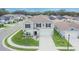 Two-story home with symmetrical windows, landscaping, two-car garage, and light grey paint at 7116 Cruz Ct, Lakeland, FL 33813