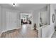 Bright foyer with wood-look floors, white trim, and views into the living spaces, office, and powder room at 7116 Cruz Ct, Lakeland, FL 33813