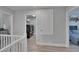 Hallway area with laundry room, bathroom, and bedroom entrances, complete with wood-look flooring at 7116 Cruz Ct, Lakeland, FL 33813