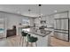 Stylish kitchen boasts stainless steel appliances, granite countertops, an island with bar seating, and modern lighting at 7116 Cruz Ct, Lakeland, FL 33813