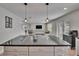 Open-concept kitchen with stainless appliances, a center island, modern lighting, and views into the living area at 7116 Cruz Ct, Lakeland, FL 33813