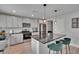 Updated kitchen featuring stainless steel appliances, granite countertops, a center island with barstools, and modern accents at 7116 Cruz Ct, Lakeland, FL 33813