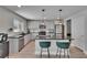 Kitchen with stainless steel appliances, granite countertops, an island with bar stools, and modern pendant lighting at 7116 Cruz Ct, Lakeland, FL 33813