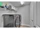 Modern laundry room with washer, dryer, shelving, and bright lighting at 7116 Cruz Ct, Lakeland, FL 33813
