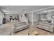 Open-concept living area featuring light-colored walls, wood-look floors, and comfortable seating arrangements at 7116 Cruz Ct, Lakeland, FL 33813