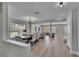 Spacious living and dining areas with wood-look floors, neutral walls, and modern lighting, perfect for gatherings at 7116 Cruz Ct, Lakeland, FL 33813